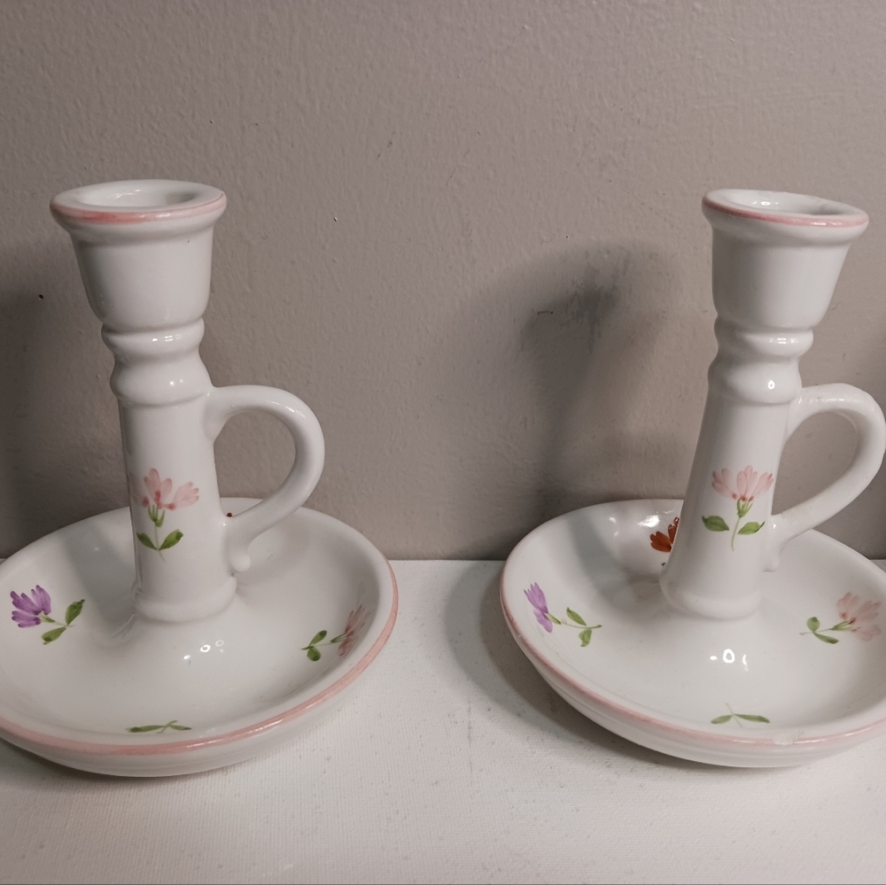 A pair of vintage floral candle holders not sure of brand made in Portugal